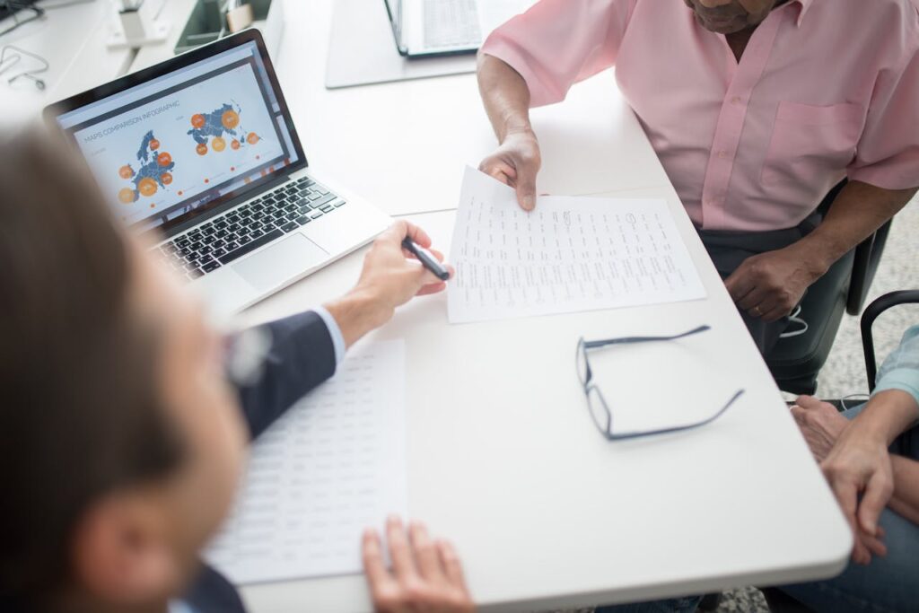 Insurance Broker Presenting an Offer to an Elderly Couple